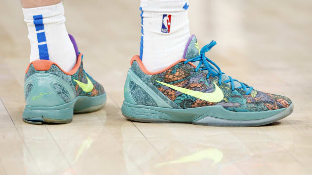 View of green and yellow Nike Kobe shoes.